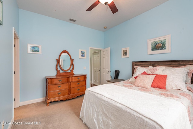 bedroom with ceiling fan and light carpet