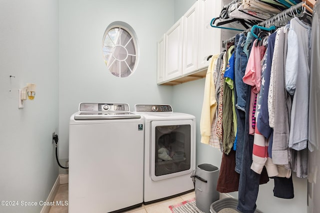 laundry area featuring cabinets, light tile patterned floors, and separate washer and dryer