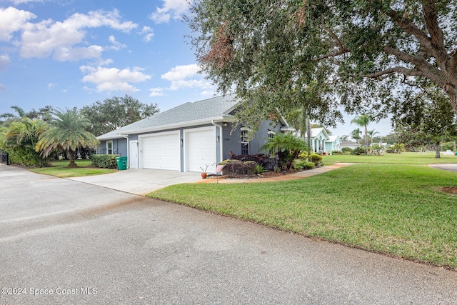 view of front of home with a garage and a front lawn