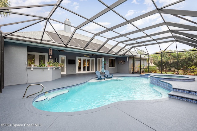 view of swimming pool with french doors, ceiling fan, a lanai, an in ground hot tub, and a patio