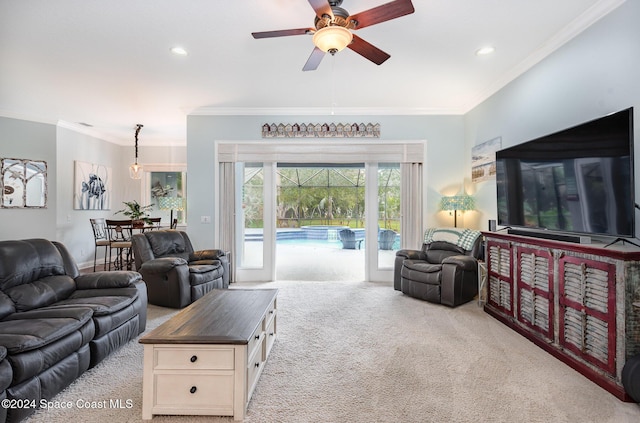 living room with light colored carpet, ceiling fan, and ornamental molding