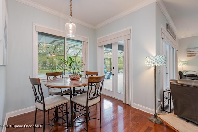 dining room featuring a wealth of natural light, crown molding, dark wood-type flooring, and french doors