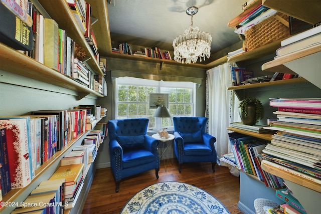 living area featuring dark wood-type flooring and a notable chandelier