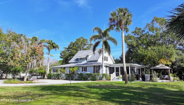 view of front facade featuring a gazebo and a front yard