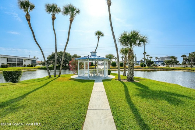 view of home's community with a gazebo, a yard, and a water view