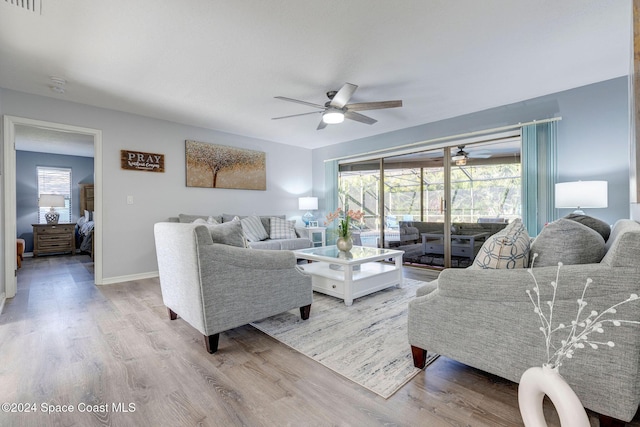 living room featuring light wood-type flooring and ceiling fan