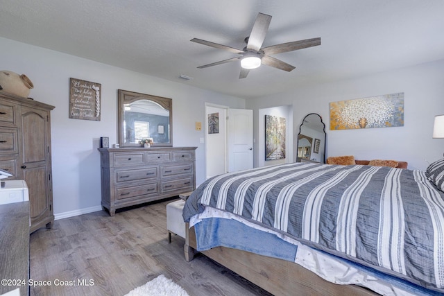 bedroom with light wood-type flooring and ceiling fan