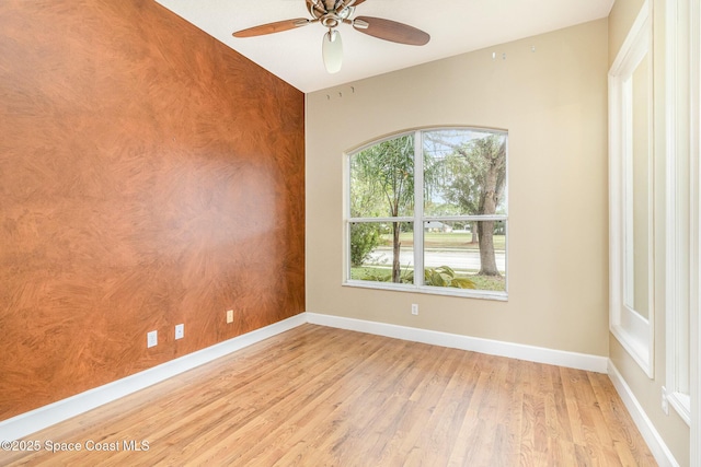 empty room with ceiling fan and light wood-type flooring