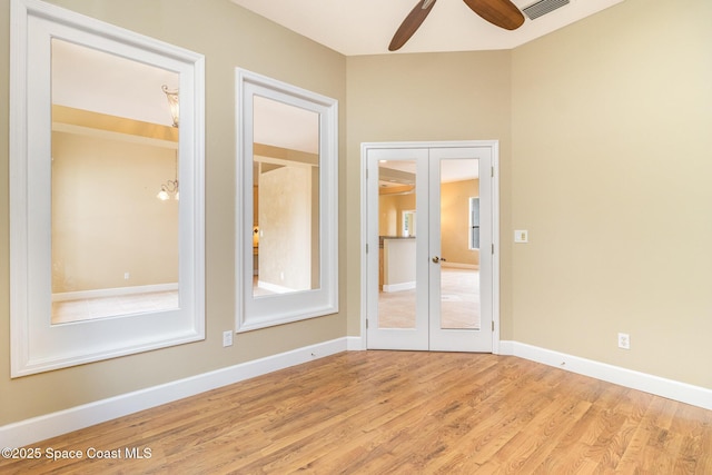 spare room with french doors, light hardwood / wood-style flooring, and ceiling fan