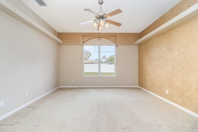 empty room with ceiling fan and carpet