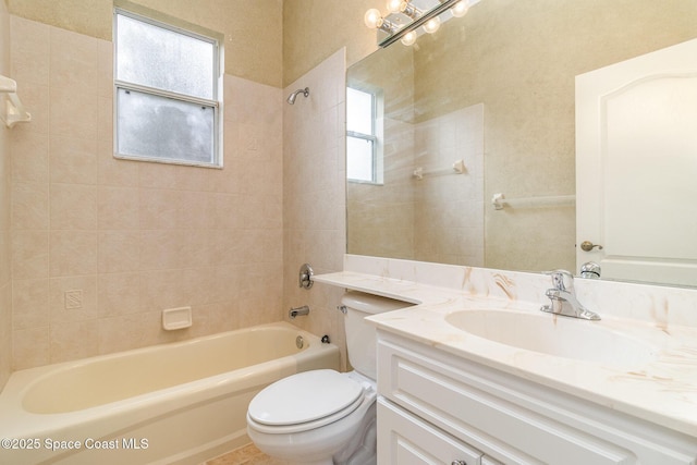 full bathroom featuring vanity, tiled shower / bath combo, toilet, and a healthy amount of sunlight