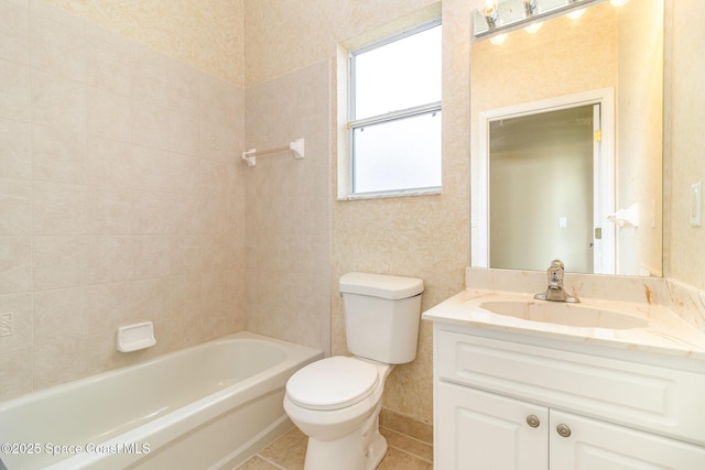 full bathroom with tile patterned flooring, vanity, tiled shower / bath combo, and toilet