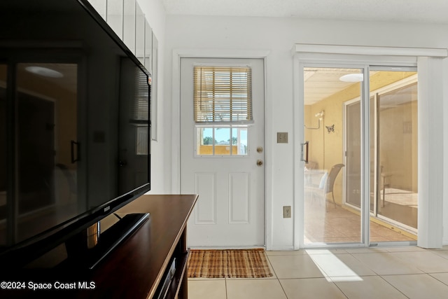 doorway to outside featuring light tile patterned floors