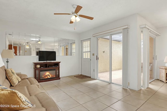 tiled living room with ceiling fan