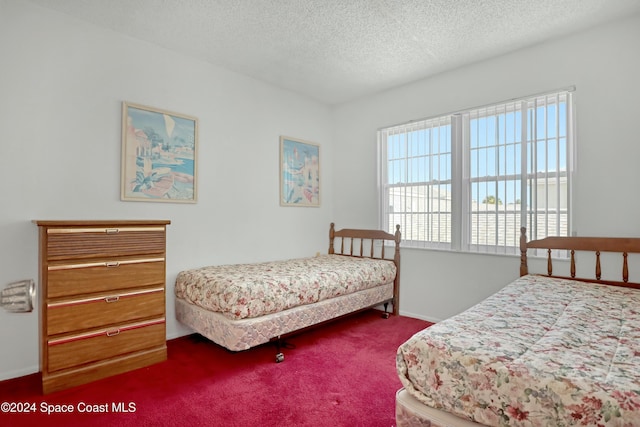 carpeted bedroom featuring a textured ceiling