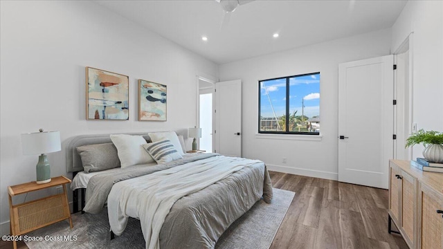 bedroom with baseboards, dark wood finished floors, and recessed lighting