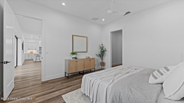 bedroom with visible vents, baseboards, wood finished floors, and recessed lighting