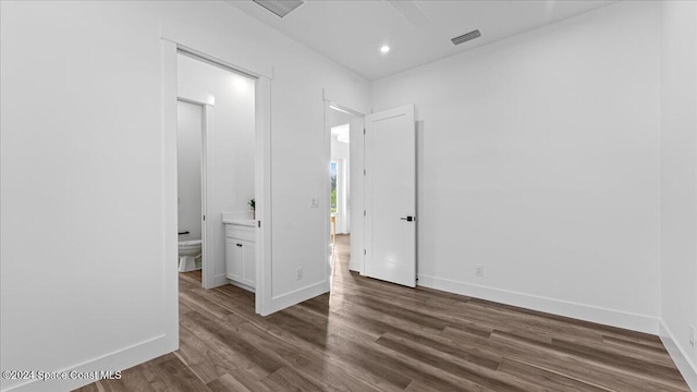 spare room featuring recessed lighting, dark wood finished floors, visible vents, and baseboards