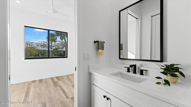 bathroom with vanity, baseboards, and wood finished floors