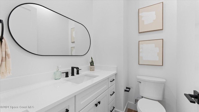 bathroom with toilet and vanity