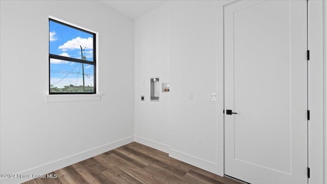 laundry area with laundry area, baseboards, dark wood-type flooring, hookup for a washing machine, and electric dryer hookup