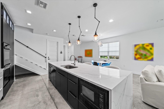 kitchen with light stone counters, stainless steel appliances, a spacious island, sink, and hanging light fixtures