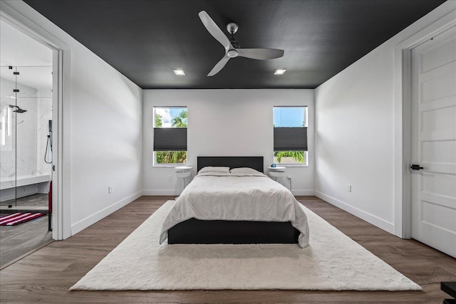 bedroom featuring multiple windows, ceiling fan, and dark wood-type flooring