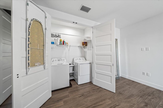 laundry room featuring separate washer and dryer and dark hardwood / wood-style floors