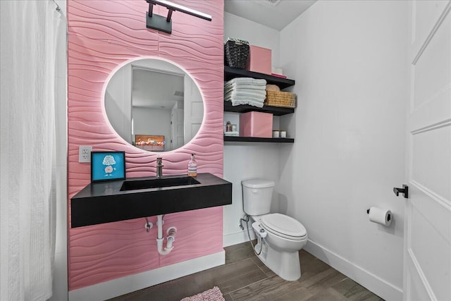 bathroom featuring vanity, hardwood / wood-style flooring, and toilet