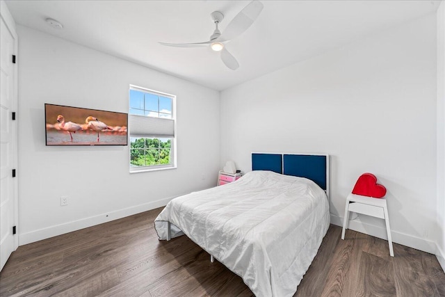 bedroom with ceiling fan and dark wood-type flooring