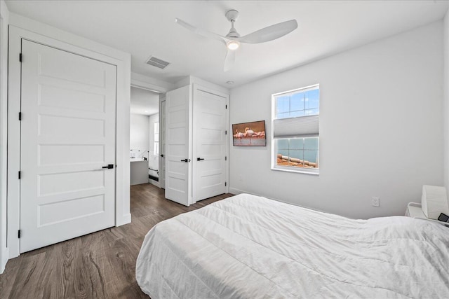 bedroom with ceiling fan and dark wood-type flooring