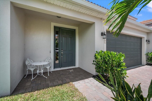 doorway to property with a garage