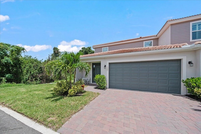 mediterranean / spanish home with a front yard and a garage