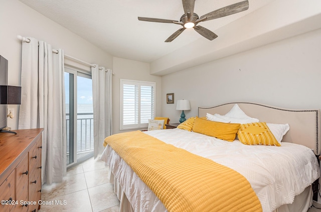 tiled bedroom with ceiling fan, access to exterior, and a water view