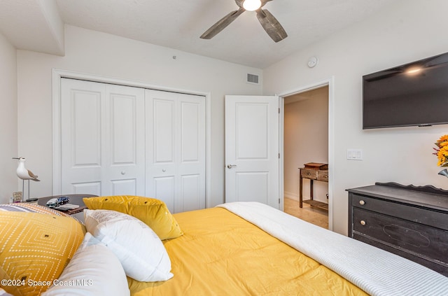 bedroom featuring ceiling fan and a closet