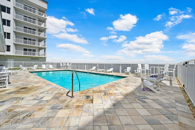 view of swimming pool with a patio area