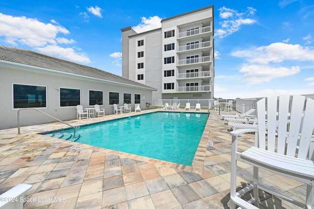 view of swimming pool featuring a patio area