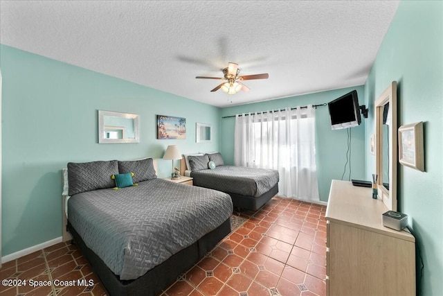 bedroom featuring ceiling fan and a textured ceiling