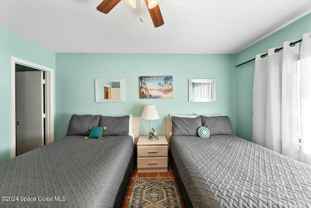 bedroom with a textured ceiling and ceiling fan