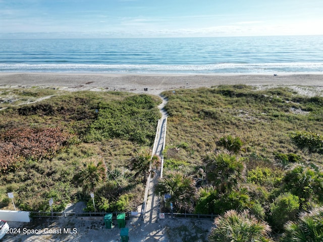 birds eye view of property featuring a water view and a view of the beach