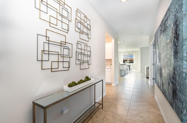 corridor featuring light tile patterned floors