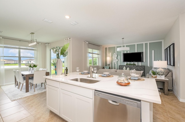 kitchen featuring dishwasher, sink, decorative light fixtures, a kitchen island with sink, and white cabinets