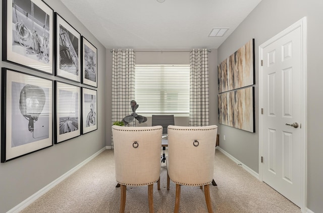 dining space featuring light colored carpet