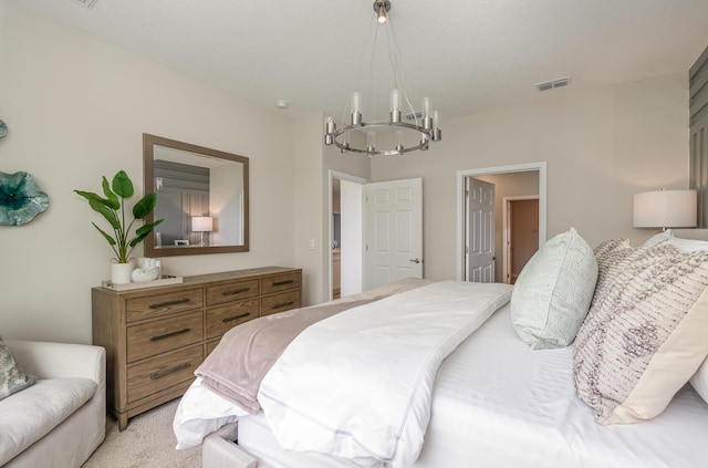 carpeted bedroom with a chandelier and a textured ceiling