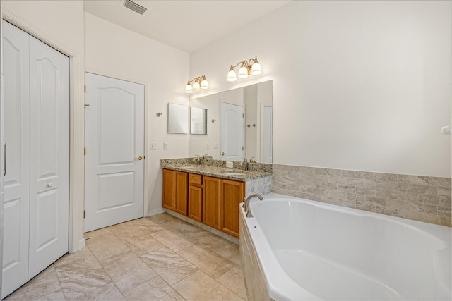 bathroom featuring a tub to relax in and vanity