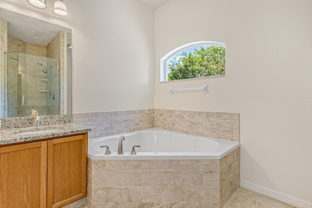 bathroom with vanity and independent shower and bath