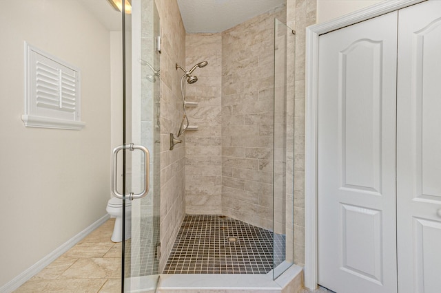 bathroom featuring an enclosed shower and toilet