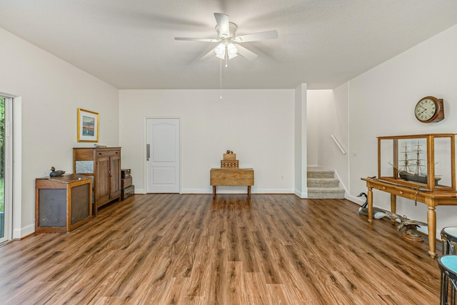 misc room featuring hardwood / wood-style floors, ceiling fan, and a textured ceiling