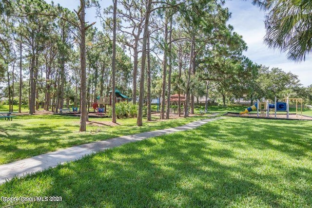 surrounding community with a playground and a lawn