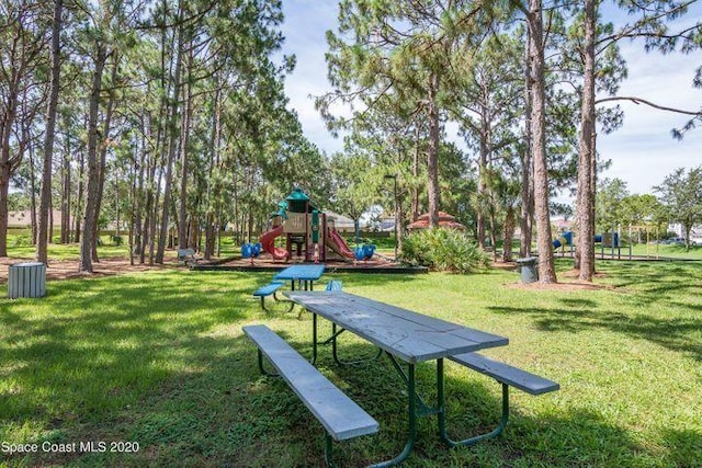 view of community featuring a lawn and a playground